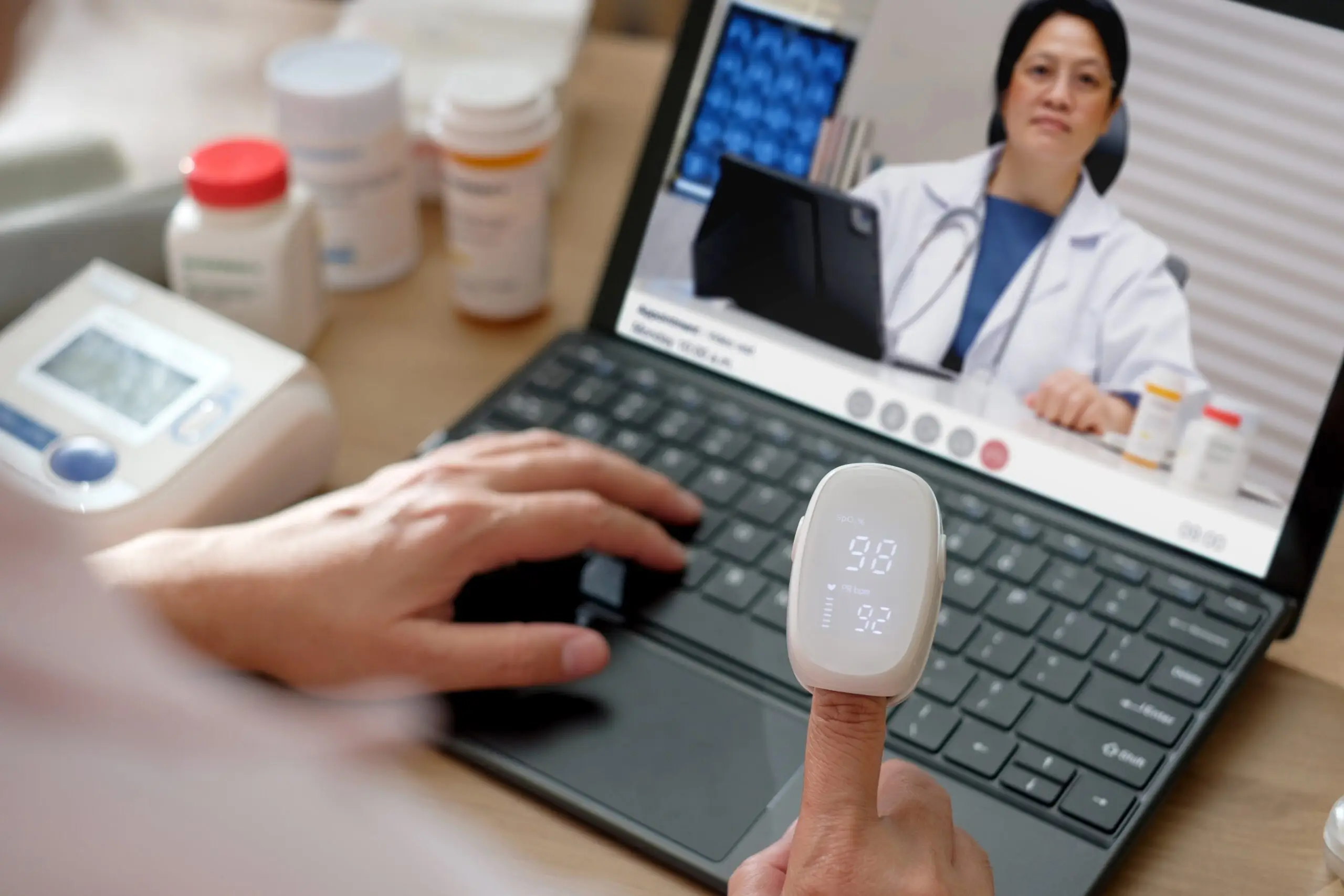 Asian Woman Using Telemedicine for Doctor Visit at Home Asian Woman Using Telemedicine for Doctor Visit at Home